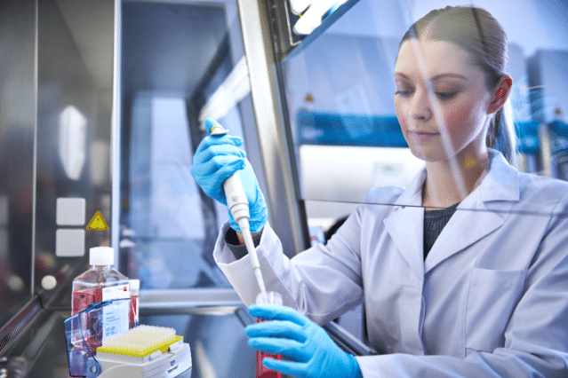 Woman wearing gloves handling chemicals